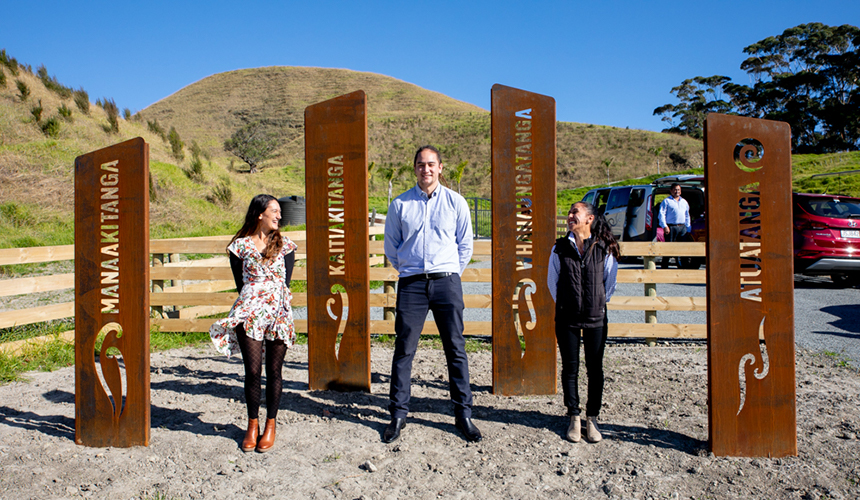3 members of the whānau standing at the entrance to the cycle path.
