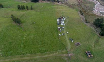 View of vehicles parked in a paddock, seen from above.