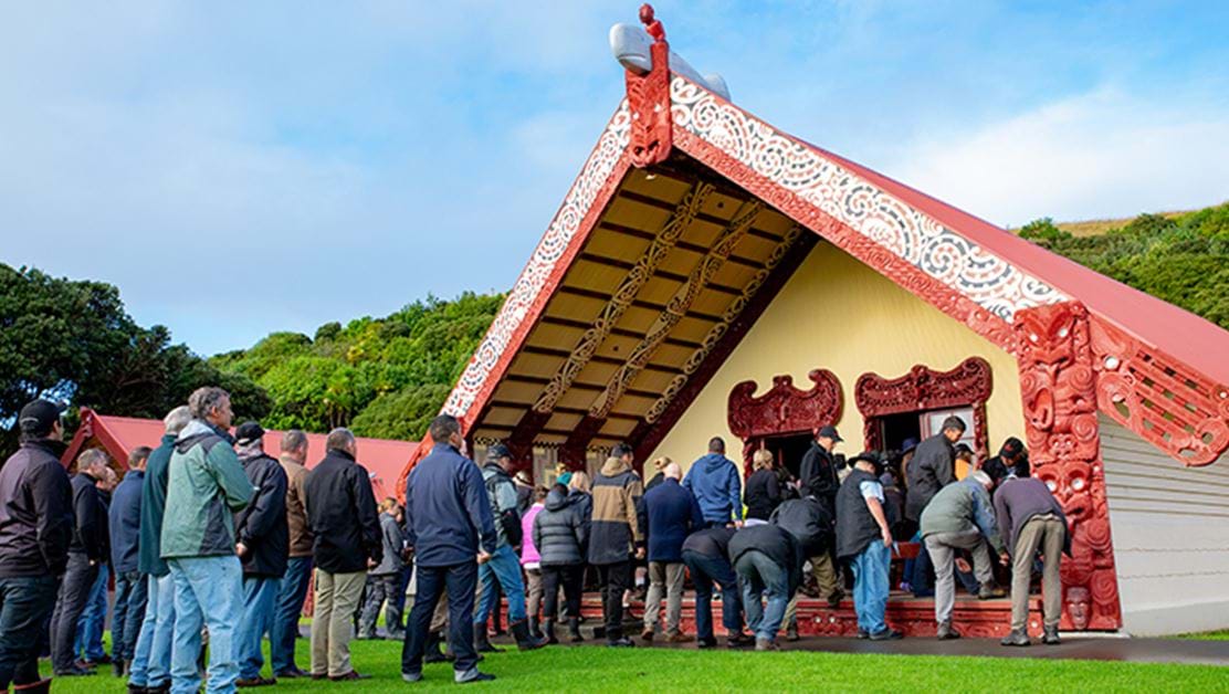 A group of people waiting to enter a marae.