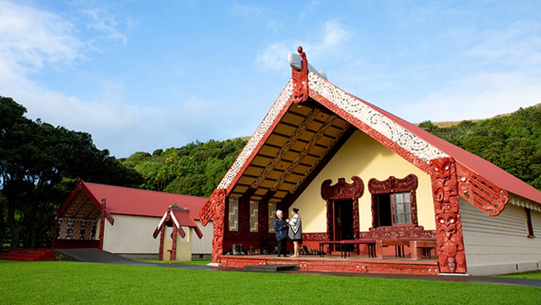 Two women standing at the marae.
