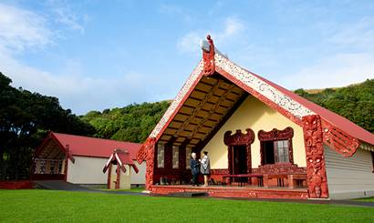 Two women standing at the marae.